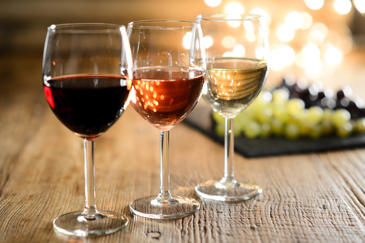 Wine and Weight Loss: three glasses of wine on table, grapes in background